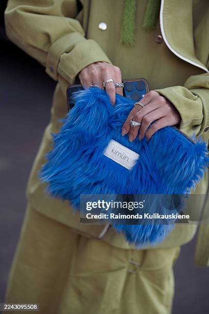 Kiana Eva wears a light green belted coat paired with a matching long skirt and blue fuzzy handbag during Yerevan Fashion Week on October 24, 2025 in...