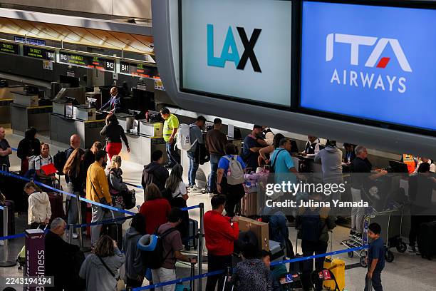 El Segundo, CA Travelers wait in line at the Tom Bradley International Terminal at LAX on Sunday, Oct. 26, 2025 in El Segundo, CA.