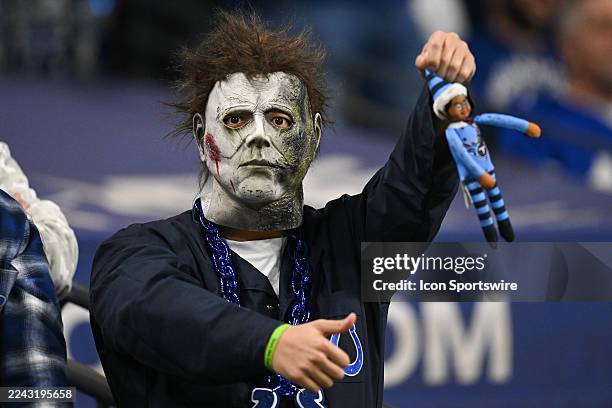 An Indianapolis Colts fan dressed in a Michael Meyers mask for Halloween cheers during the NFL game between the Tennessee Titans and the Indianapolis...