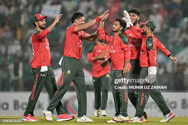 Bangladesh's Taskin Ahmed celebrates with teammates after taking the wicket of est Indies' Sherfane Rutherford during the first Twenty20...