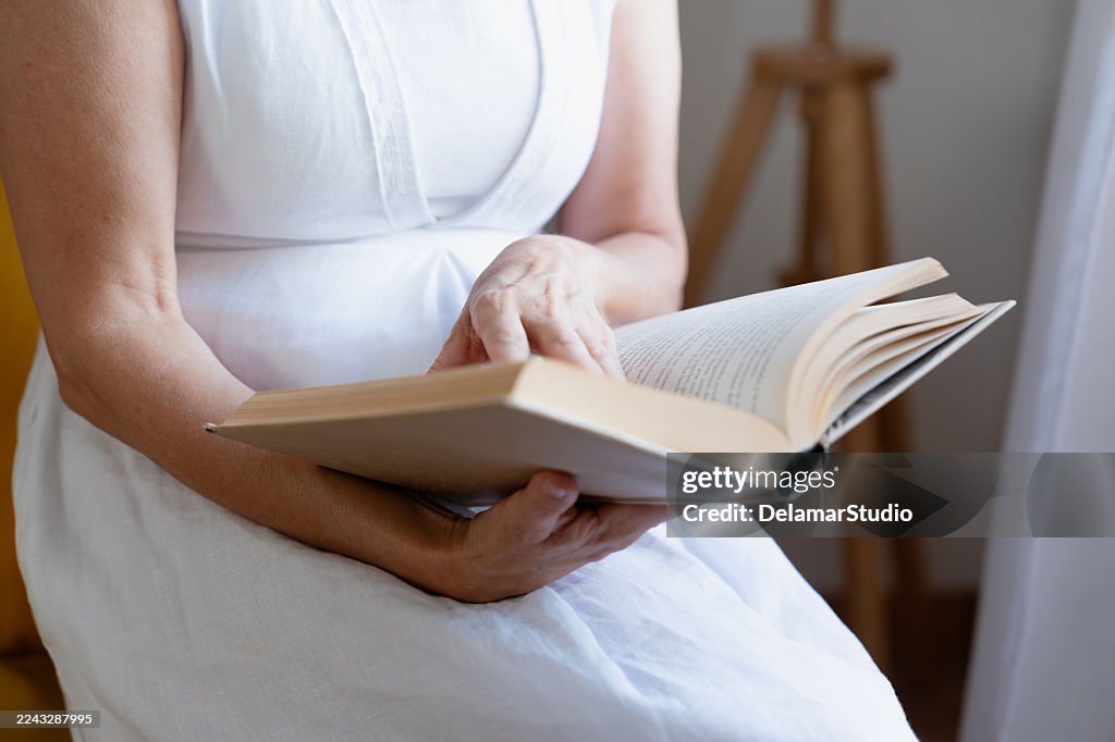 Woman reading book, enjoying quiet leisure time