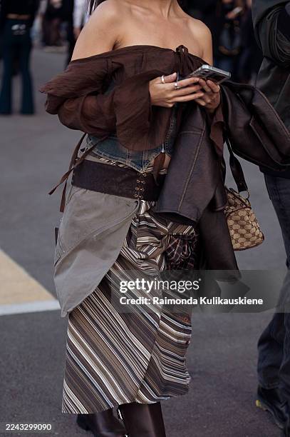 Guest wears a beige fitted cardigan over a black lace-trim slip dress, styled with black leather boots and a padded woven shoulder bag during Yerevan...