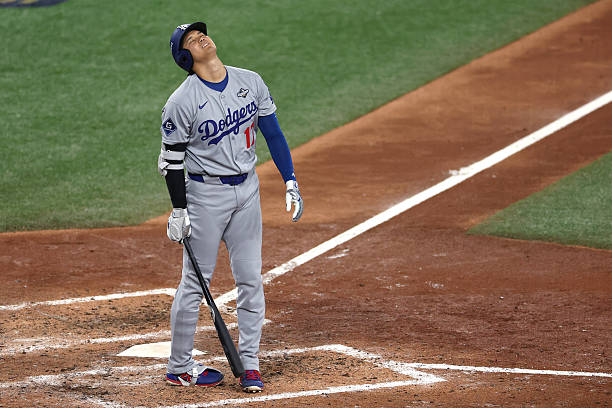 Shohei Ohtani of the Los Angeles Dodgers reacts after hitting a foul ball against the Toronto Blue Jays during the eighth inning in game two of the...