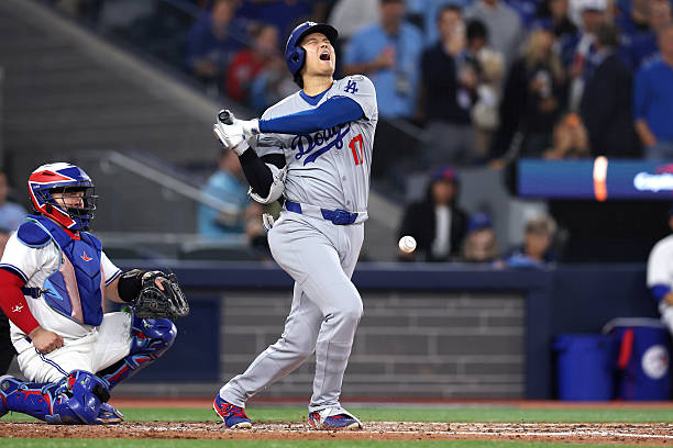 Shohei Ohtani of the Los Angeles Dodgers reacts after hitting a foul ball against the Toronto Blue Jays during the eighth inning in game two of the...