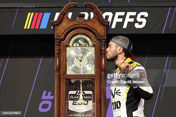 Taylor Gray, driver of the Operation 300 Toyota, kisses the Ridgeway grandfather clock in victory lane after winning the NASCAR Xfinity Series IAA...