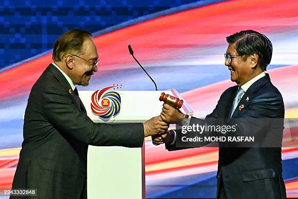 Philippines' President Ferdinand Marcos Jr is given the ceremonial gavel by Malaysia's Prime Minister Anwar Ibrahim during the ASEAN chairmanship...