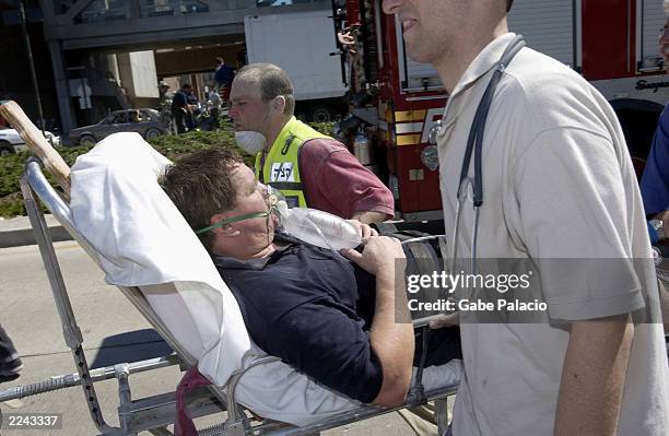 Fireman is removed on a stretcher from the scene of the colapsed World Trade Center. Streets of lower Manhattan with fireman, police, and rescue...