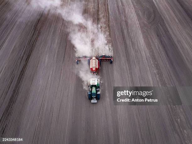 aerial view of a tractor plowing a field - plowed field stock pictures, royalty-free photos & images