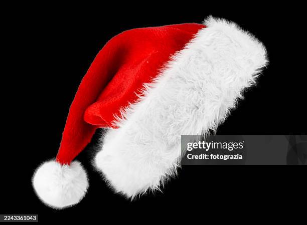 santa hat on black background - cappello da babbo natale foto e immagini stock