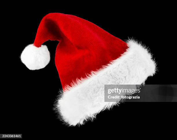 santa hat isolated on black background — red christmas cap with white fur trim - hat stock pictures, royalty-free photos & images