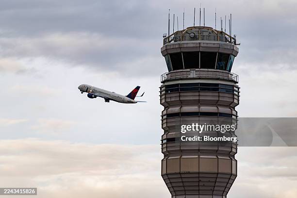 Delta Airlines plane takes off near the air traffic control tower at Ronald Reagan Washington National Airport in Arlington, Virginia, US, on...