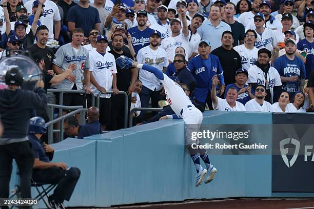 Los Angeles, CA, October 2025: Los Angeles Dodgers first baseman Enrique Hernández dives into the stands to make the catch on a pop fly ball from...
