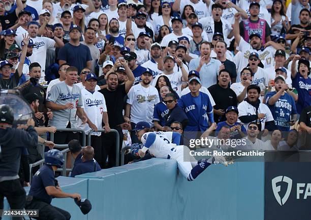 Los Angeles, CA, October 2025: Los Angeles Dodgers first baseman Enrique Hernandez dives into the stands to make the catch on a pop fly ball from...