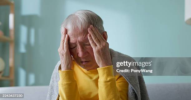 asian elderly get cold headache at home - elderly dizzy stock pictures, royalty-free photos & images