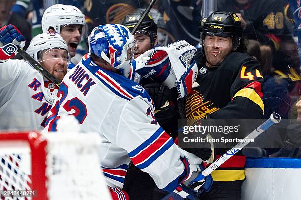 New York Rangers goaltender Jonathan Quick pushes Vancouver Canucks left wing Kiefer Sherwood during the third period of an NHL game between the New...