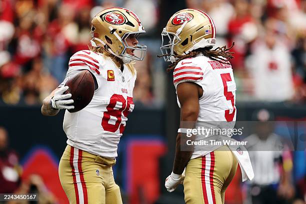 George Kittle of the San Francisco 49ers celebrates with Demarcus Robinson after scoring a touchdown in the second quarter of the game against the...