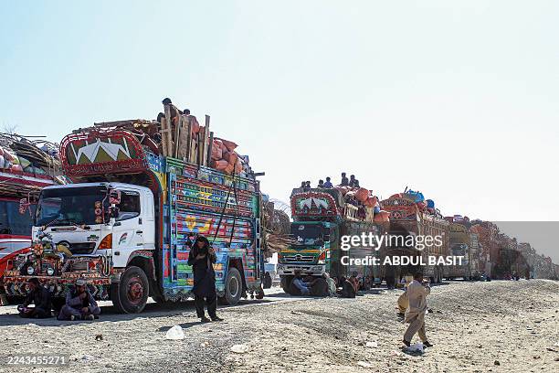 Afghan refugees along with their belongings on trucks await deportation to Afghanistan near the Pakistan-Afghanistan border in Chaman on October 29,...