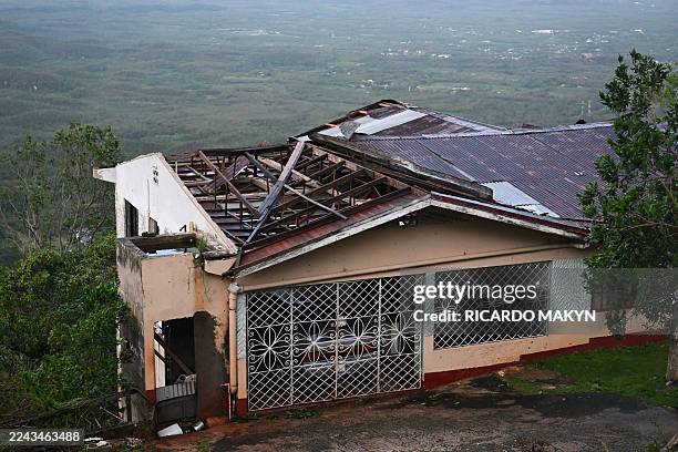 House with a damaged roof is seen after the passage of Hurricane Melissa in Manchester, Jamaica, on October 29, 2025. Hurricane Melissa ripped up...
