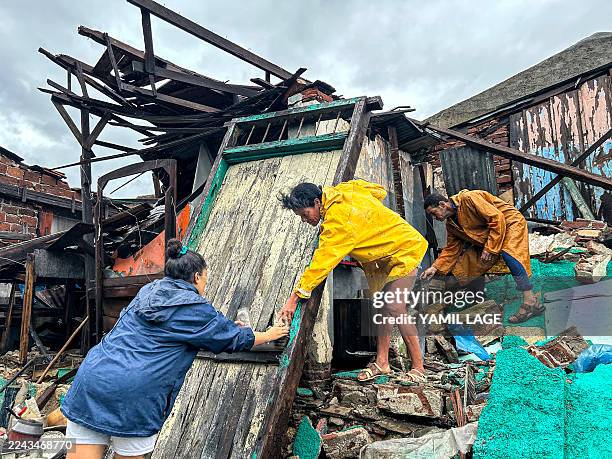 Family salvages belongings from the rubble of their home after it collapsed during Hurricane Melissa's passage through Santiago de Cuba, Cuba, on...