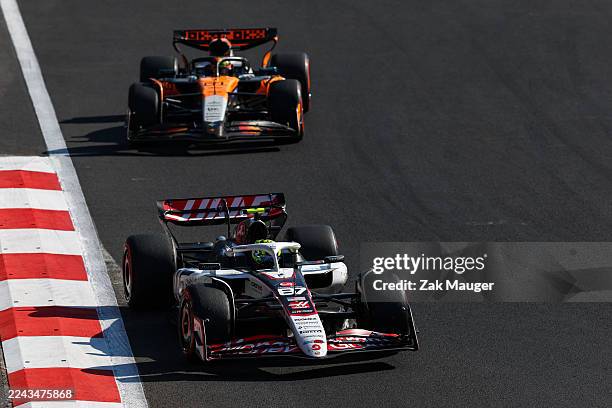 Oliver Bearman of Great Britain driving the Haas F1 VF-25 Ferrari leads Oscar Piastri of Australia driving the McLaren MCL39 Mercedes on track during...