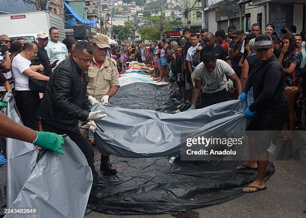 Residents recover around 70 bodies in the woods of the Penha Complex, in the northern part of Brazil's Rio de Janeiro, one day after the deadliest...
