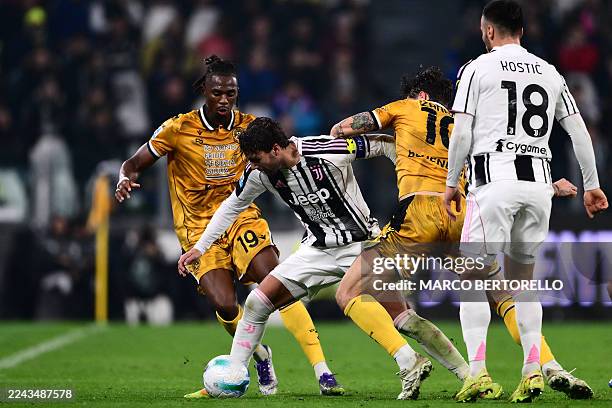 Juventus Italy Midfielder Manuel Locatelli fights for the ball with Udinese's Italian forward Nicolo Zaniolo and Udinese's Dutch defender Kingsley...