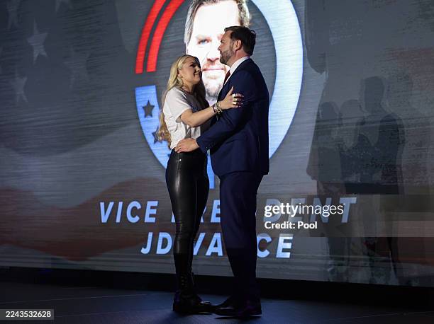 Erika Kirk, widow of Turning Point USA founder Charlie Kirk, and U.S. Vice President JD Vance embrace on stage during a Turning Point USA event at...
