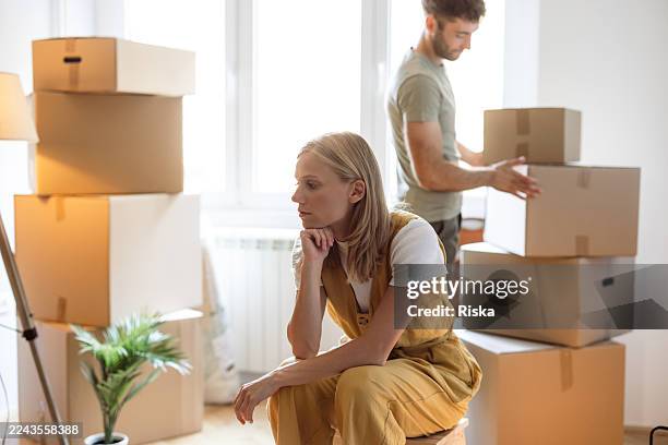 junge frau, die sich während eines auszugsprozesses unwohl fühlt - partnertrennung stock-fotos und bilder