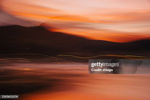 abstract background of light trail over the sea at sunset - ethereal stock pictures, royalty-free photos & images
