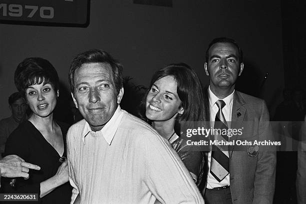 American singer Andy Williams, wearing a light-coloured sweater over a white shirt, and his wife, Franco-American singer and actress Claudine Longet,...