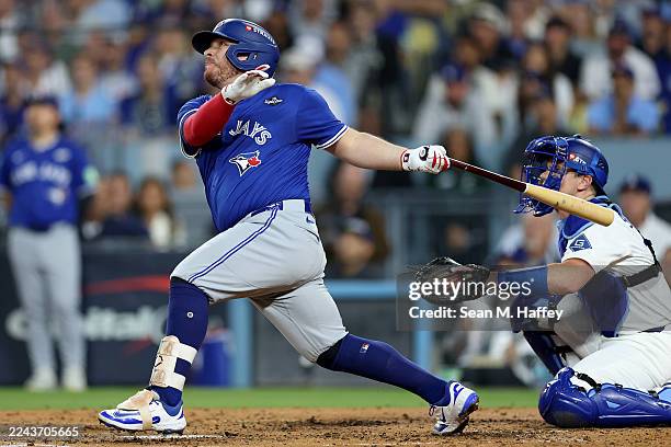 Alejandro Kirk of the Toronto Blue Jays hits a three-run home run against the Los Angeles Dodgers during the fourth inning in game three of the 2025...