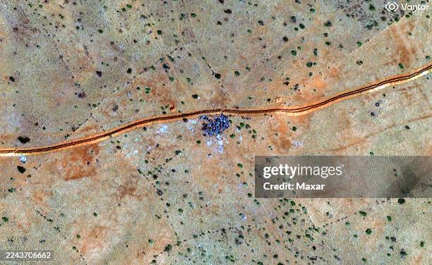 Vantor satellite imagery shows a cluster of burned vehicles along a dirt berm. Please use: Satellite image 2025 Vantor.
