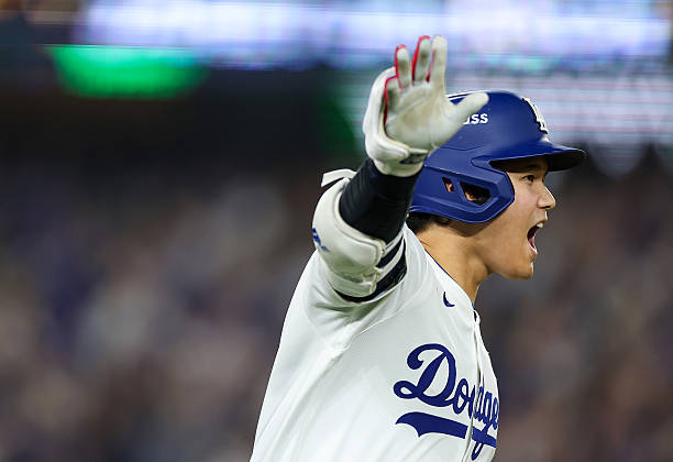 Shohei Ohtani of the Los Angeles Dodgers rounds the bases after hitting a home run during the seventh inning against the Toronto Blue Jays in game...