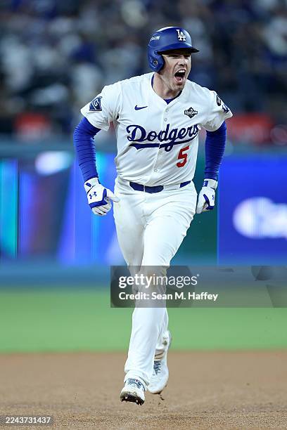 Freddie Freeman of the Los Angeles Dodgers rounds the bases after hitting a walk-off home run during the 18th inning against the Toronto Blue Jays in...