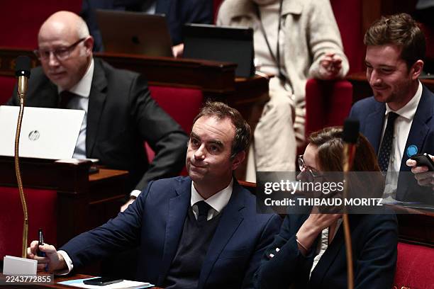 France's Prime Minister Sebastien Lecornu flanked by France's Public Accounts Minister Amelie de Montchalin looks on during a parliamentary debate on...