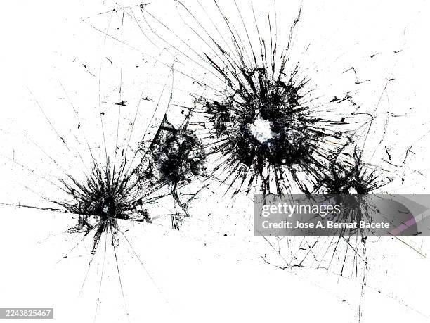 bullet holes in a broken sheet of transparent glass with cracks on a white background. - einschussloch stock-fotos und bilder