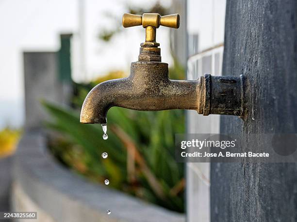 drinking water faucet slowly dripping water into the open air. - drought stock pictures, royalty-free photos & images