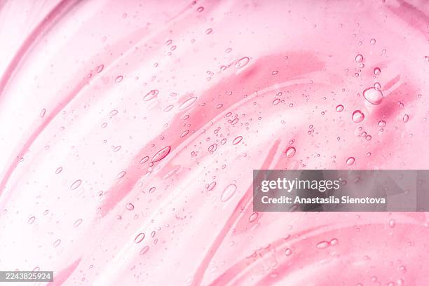 pink gel texture with bubbles on abstract background - shower gel stock pictures, royalty-free photos & images
