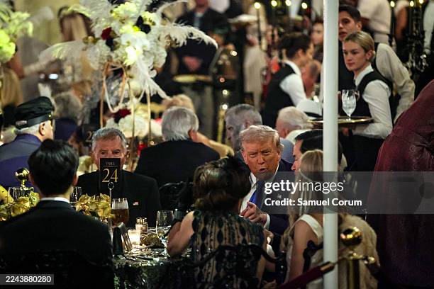 President Donald Trump talks with guests during a Halloween party at his Mar-a-Lago estate on October 31, 2025 at Palm Beach, Florida. Trump is...