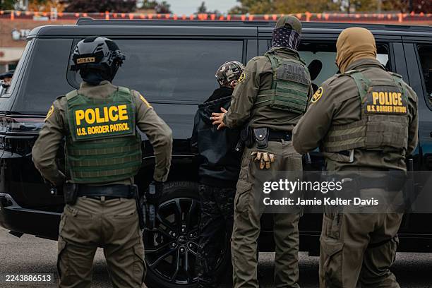 Federal immigration agents arrest a man in the parking lot of an H-Mart grocery store on October 31 in Niles, Illinois. Chief Patrol Agent of the El...