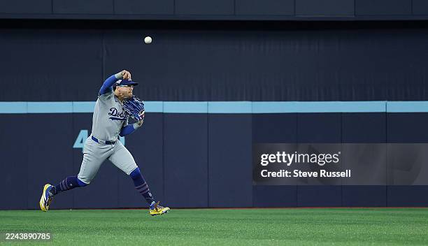 Enrique Hernández of the Los Angeles Dodgers fires the ball to second baseman Miguel Rojas of the Los Angeles Dodgers to complete a double play as...