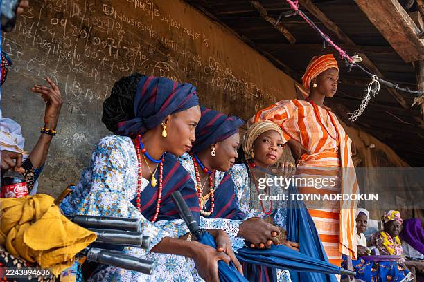 Brides sit outside Alawon's palace during the Awon mass wedding in Shao, Kwara State, on October 31, 2025. The mass wedding is a festival among the...
