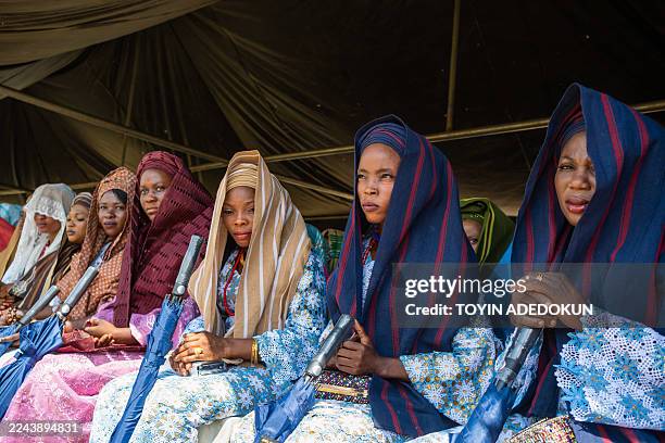 Brides look on during the Awon mass wedding in Shao, Kwara State, on October 31, 2025. The mass wedding is a festival among the people of Shao...