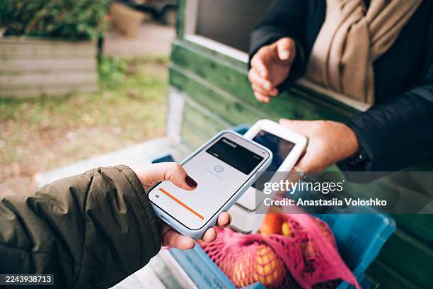 contactless payment at a local market - digital wallet stock pictures, royalty-free photos & images