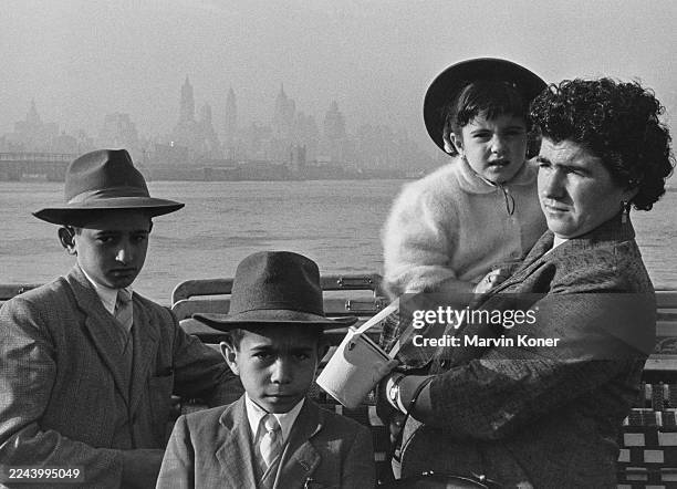 An Italian immigrant family, Carmela and her three children dressed in their finest, prepare to disembark in New York as their ship arrives in...