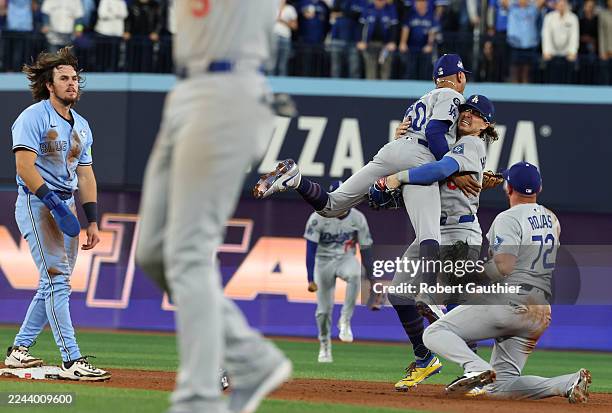 Toronto, Ontario, Friday, October 31, 2025 - Los Angeles Dodgers shortstop Mookie Betts jumps into the arms of Los Angeles Dodgers first baseman...