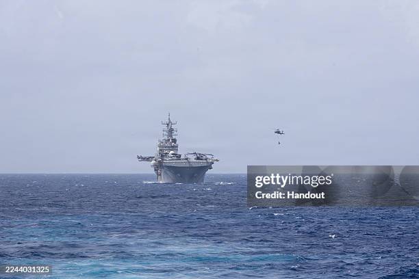 In this handout provided by the U.S. Navy, The Wasp-class amphibious assault ship USS Iwo Jima conducts a replenishment-at-sea with the Henry J....