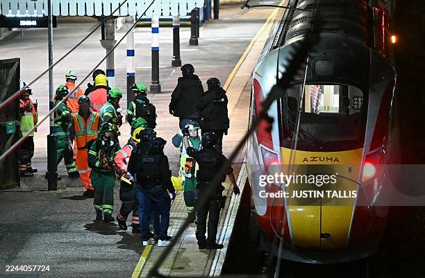 Police officers and members of the Emergency services work alongside an LNER Azuma train at Huntingdon Station in Huntingdon, eastern England, on...
