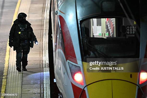 Police officer walks on the platform alongside an LNER Azuma train at Huntingdon Station in Huntingdon, eastern England, on November 1 following a...