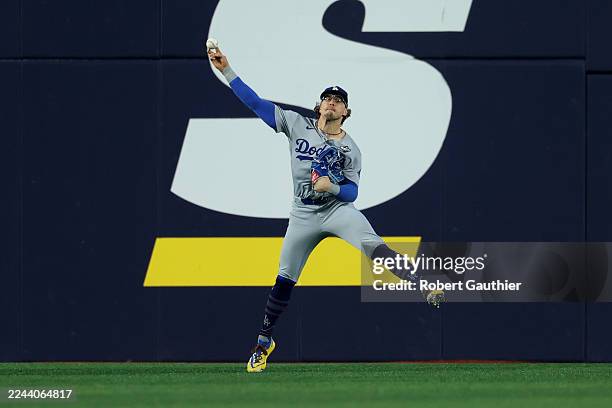 Toronto, Ontario, Saturday, November 1, 2025 - Los Angeles Dodgers first baseman Enrique Hernández fields the ball ht by Toronto Blue Jays' George...